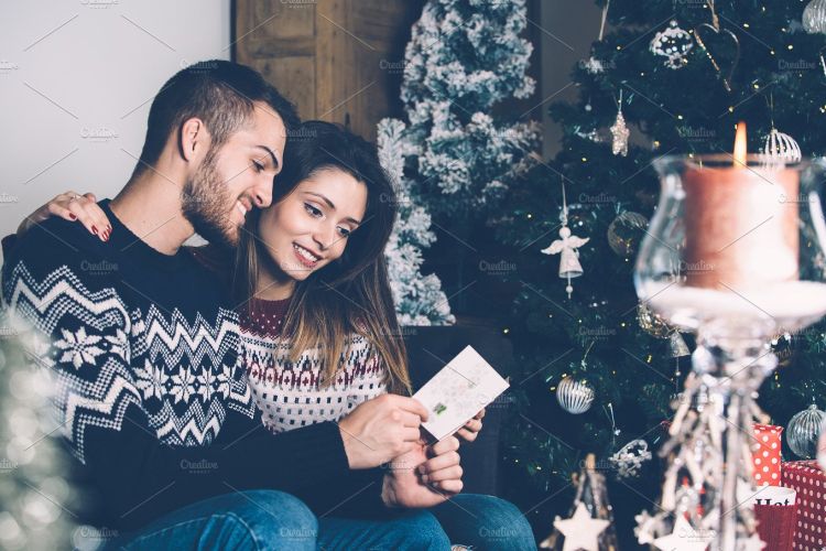 Lovers reading Christmas greetings